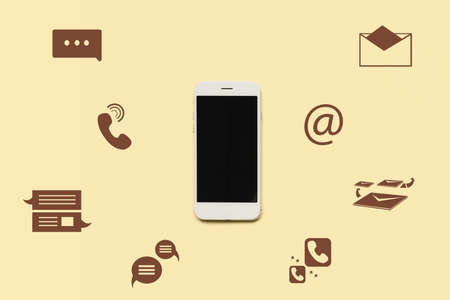 Mobile phone with blank screen and icons on yellow backgroundの写真素材