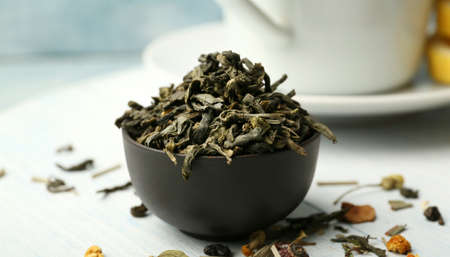 Bowl with dry tea leaves on table, closeupの写真素材