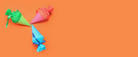 School cones on orange background with space for text, top view
