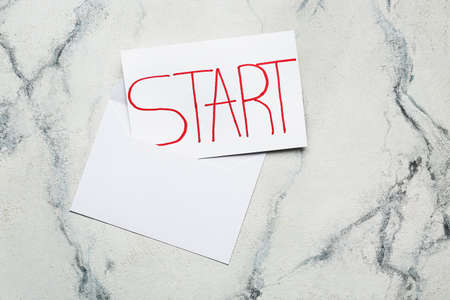 Paper sheet with word START and envelope on white backgroundの写真素材