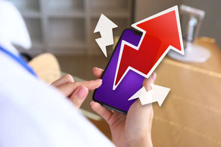 Woman using mobile phone in office, closeup. Concept of marketing strategy