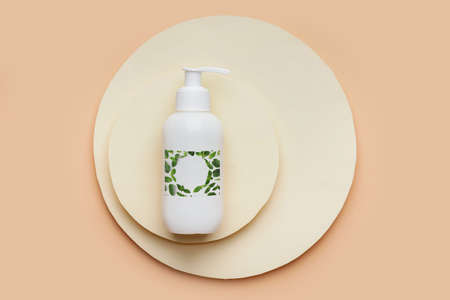 Bottle of cosmetic product on beige background, top viewの写真素材