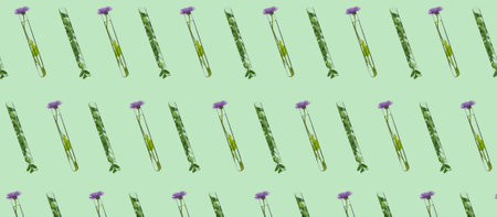 Test tubes with flowers on green background. pattern for designの写真素材