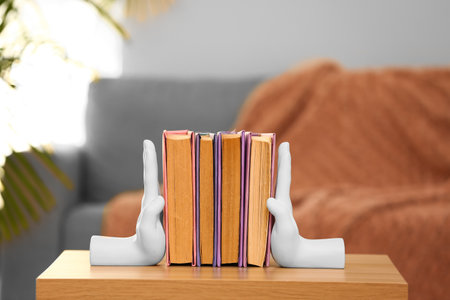 Stylish holder with books on table in living roomの写真素材