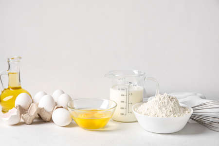 Different ingredients for baking on table against white backgroundの写真素材