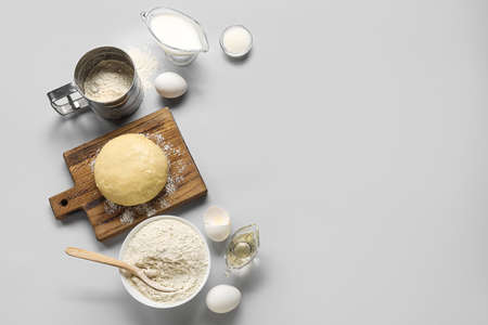Set of ingredients for baking with raw dough on white backgroundの写真素材