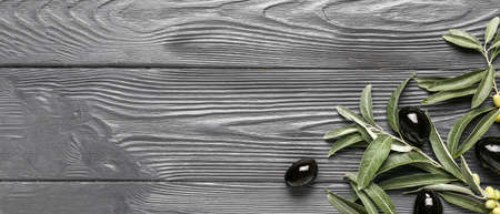 Tasty black olives on wooden background with space for textの写真素材