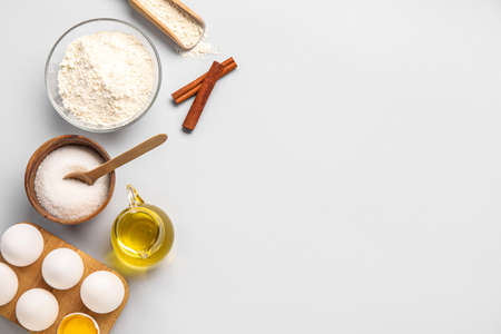 Chicken eggs and ingredients for baking on light backgroundの写真素材