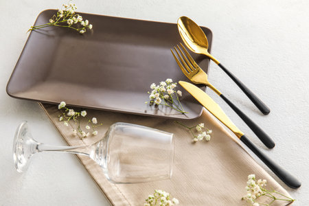 Stylish table setting with gypsophila flowers on white backgroundの写真素材