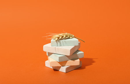 Showcase pedestal with wheat ear on color backgroundの写真素材