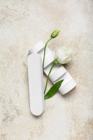 Plaster podium and eustoma flower on light background