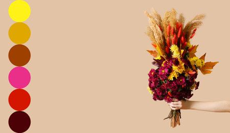 Female hand with beautiful autumn bouquet on beige background. Different color patternsの写真素材