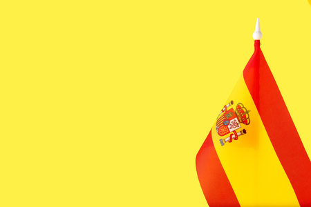 National flag of Spain on yellow backgroundの写真素材