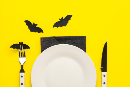 Table setting with bats made of paper on yellow backgroundの写真素材
