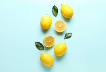 Composition with lemons and leaves on color backgroundの写真素材