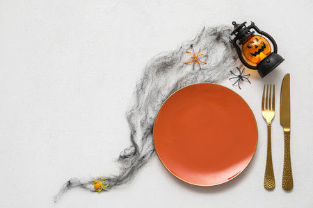 Table setting with decor for Halloween celebration on white backgroundの写真素材