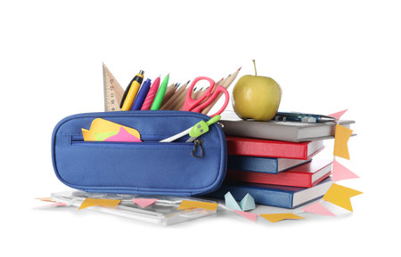 Blue pencil case with school stationery, apple and books on white backgroundの写真素材