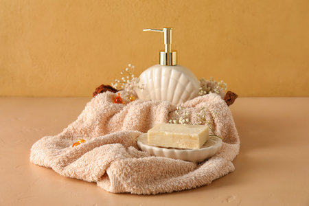 Composition with soap, towel and gypsophila flowers on color backgroundの写真素材