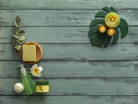 Composition with different cosmetic products and burning candles on color wooden backgroundの写真素材