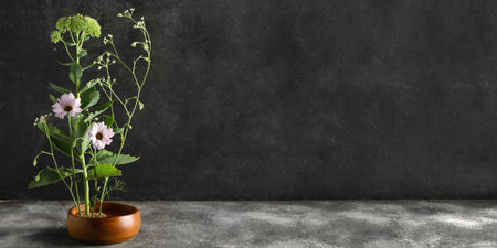 Beautiful ikebana on dark background with space for text