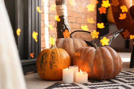 Halloween pumpkins with candles and witch's hat in roomの写真素材