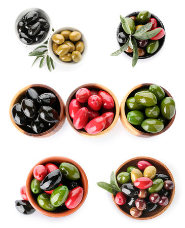 Different types of tasty olives in bowls on white background, top viewの写真素材