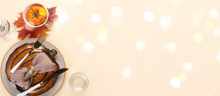 Beautiful autumn table setting on beige background with space for textの写真素材