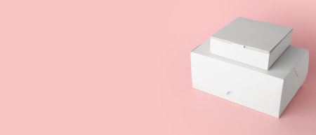 Blank cardboard boxes on pink background with space for textの写真素材