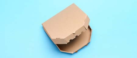 Cardboard pizza box on light blue background