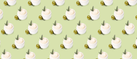 Many jars of cream with olive oil extract on green background. pattern for designの写真素材