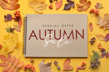 Poster for autumn sale with leaves and notebook on yellow background