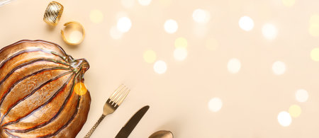 Beautiful autumn table setting on beige background with space for textの写真素材