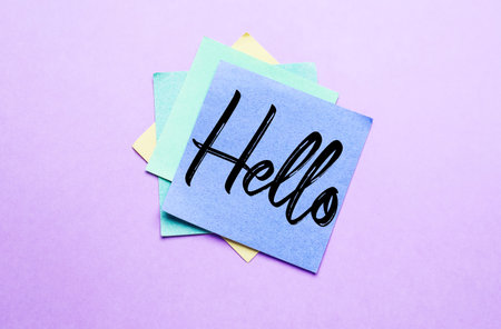Sticky note with word HELLO on lilac backgroundの写真素材