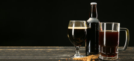 Glassware with fresh beer on table against dark background. banner designの写真素材
