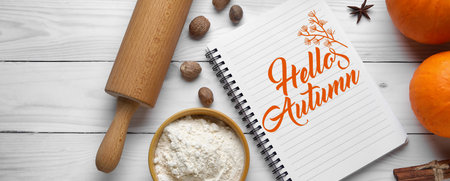 Notebook and ingredients for pumpkin pie on white wooden background, top view