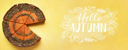 Cut pumpkin pie on yellow background. hello autumnの写真素材