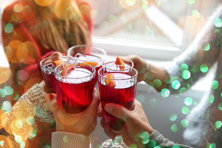 Friends drinking delicious mulled wine at party, closeupの写真素材