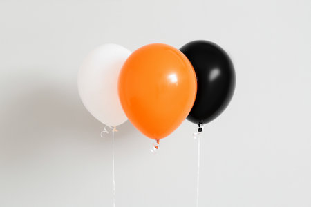 Halloween balloons near light wallの写真素材