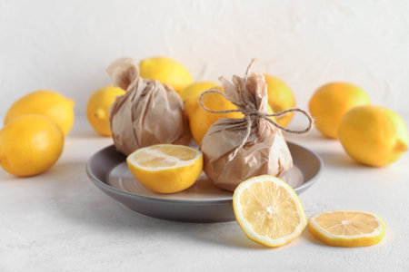 Plate with fresh lemons on light backgroundの写真素材