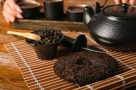 Dry pressed puer tea on wooden table, closeupの写真素材