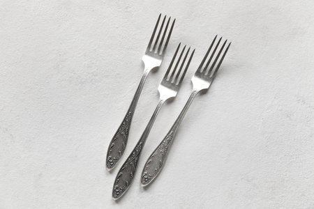 Silver forks on white background, top viewの写真素材