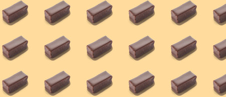 Many tasty bird's milk candies on beige background. pattern for designの写真素材