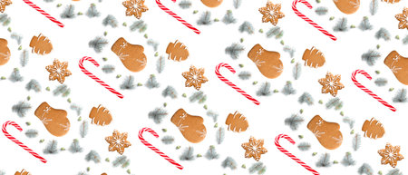 Many gingerbread cookies, candy canes and Christmas tree branches on white background. pattern for designの写真素材