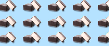 Many tasty bird's milk candies on light blue background. pattern for designの写真素材