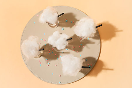 Shots with tasty cotton candy cocktail on color backgroundの写真素材