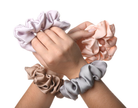Female hands with scrunchies on white backgroundの写真素材