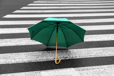 Bright umbrella on road zebraの写真素材