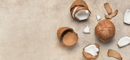 Ripe cut coconuts on grunge background with space for text
