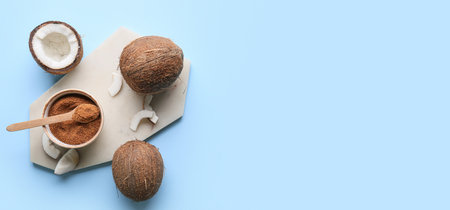 Composition with sweet coconut sugar on light blue background with space for text, top view