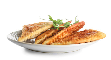 Plate with tasty chebureks and sprouts on white backgroundの写真素材